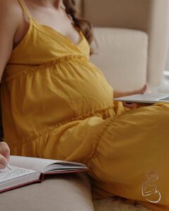A pregnant woman writing a birth plan
