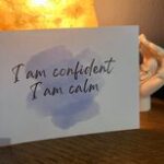 positive affirmation card for labour leaning on a salt rock lamp