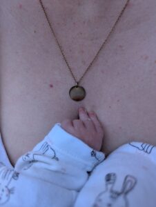 Hypnobirthing babys hand on its Mummy's chest